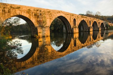 Roman bridge of Ponte do Porto at sunset in Braga, the north of clipart