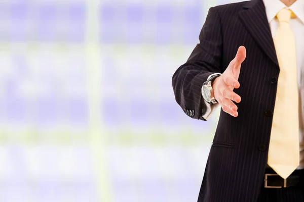 Een zakenman met een open hand klaar om een deal zegel op kantoor — Stockfoto