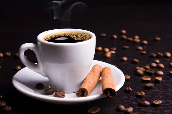 stock image Cup of hot drink with coffee beans