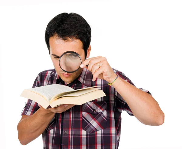 Young man reading a interesting book with magnifying glass, isol — Stock Photo, Image