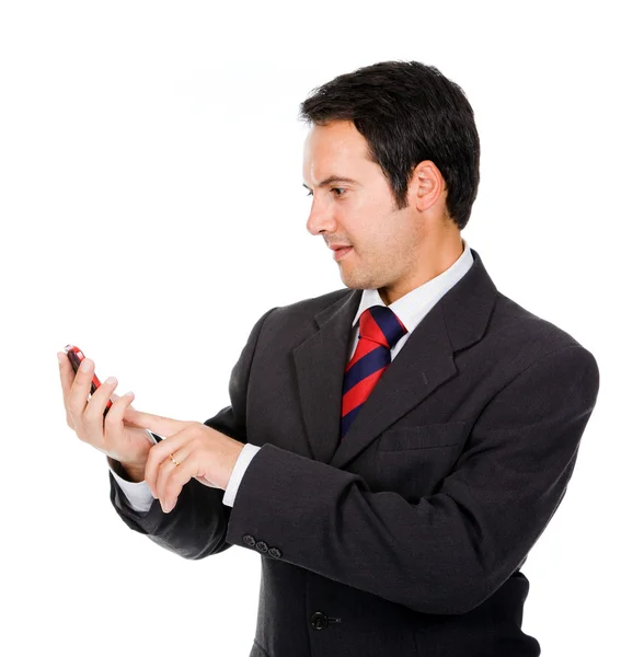 Happy business man reading an SMS on cellphone against white — Stock Photo, Image