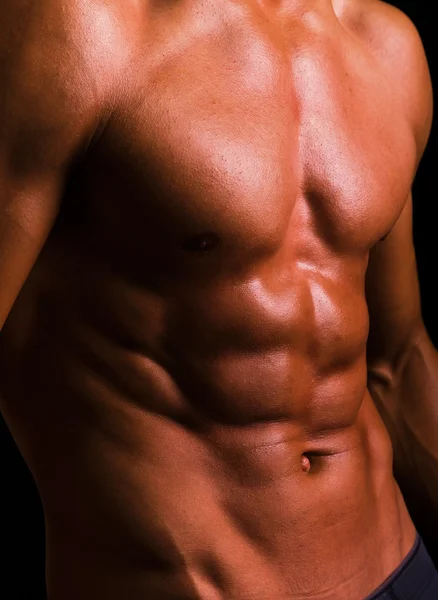 Torso of an athletic man on black background — Stock Photo, Image