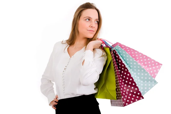 Bella giovane donna che tiene borse della spesa contro lo sfondo biancogr — Foto Stock