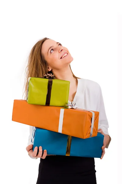 Smiling beautiful woman holding gifts and looking up on white ba — Stock Photo, Image