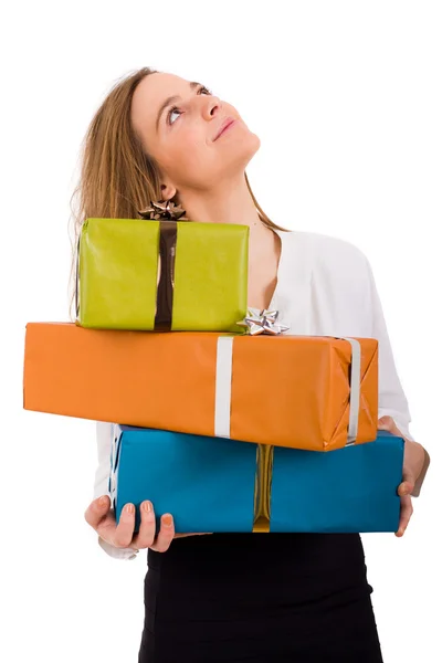 Beautiful young woman with lots of gifts looking up on white bac — Stock Photo, Image