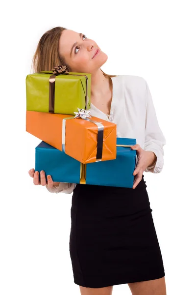 Beautiful young woman with lots of gifts on white background — Stock Photo, Image