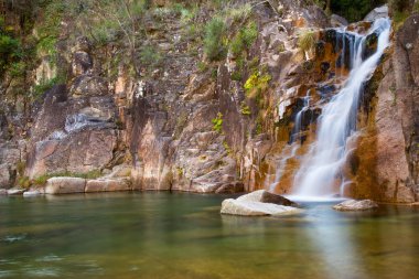 Deep forest Waterfall in Geres national park, north of Portugal. clipart