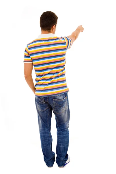 Young casual man pointing against white background — Stock Photo, Image
