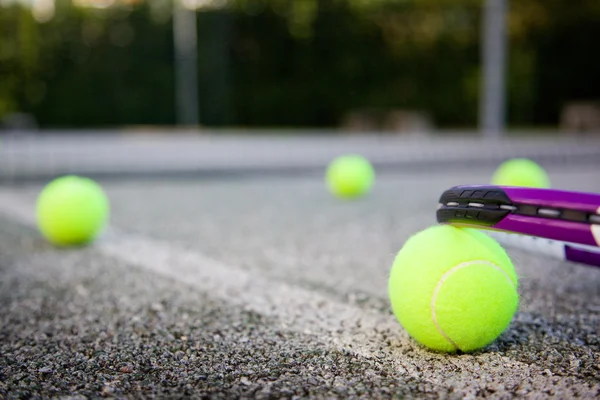 Pelota de tenis y raqueta en la línea de cancha — Foto de Stock