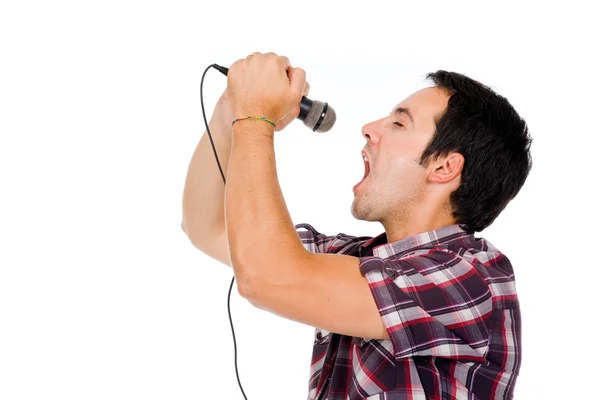 Yakışıklı bir genç adam mikrofon, ayrı tutulan şarkı görüntüsü — Stok fotoğraf