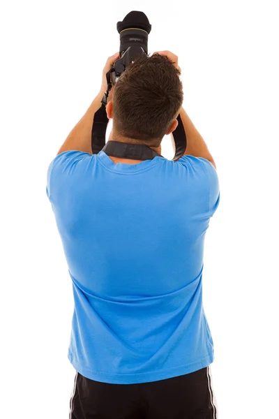 Młody fotograf z kamery z tyłu, na białym tle — Zdjęcie stockowe