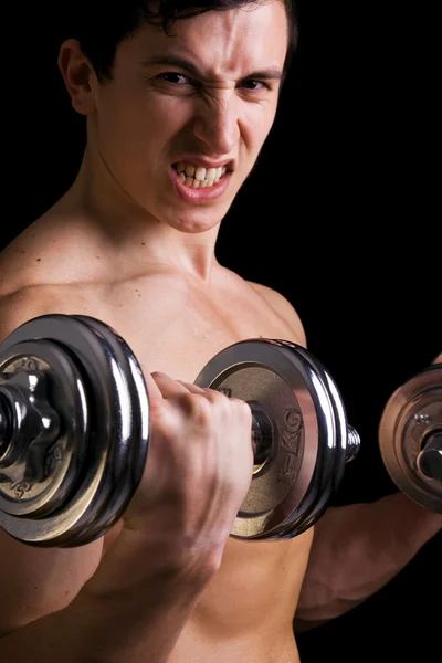 Fitness - powerful muscular man lifting weights — Stock Photo, Image