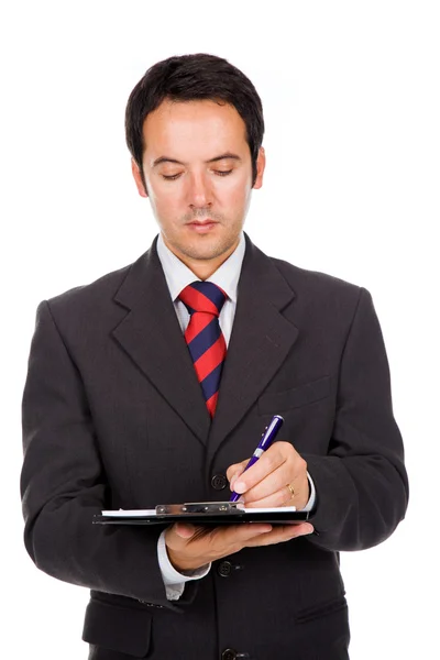 Portrait d'un jeune homme d'affaires réfléchi prenant des notes contre w — Photo