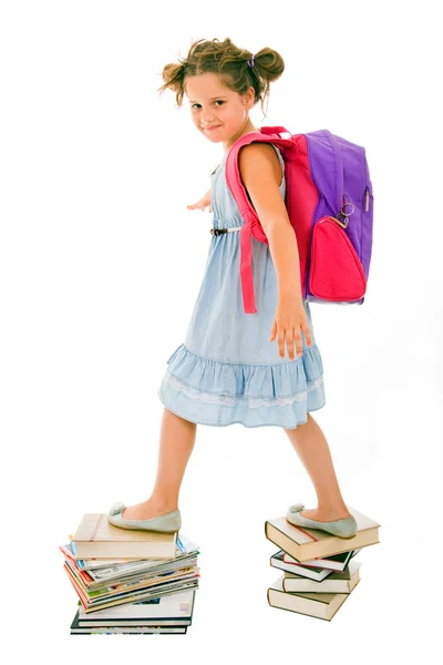 Portrait of litle girl with backpack walking from top to top of — Stock Photo, Image