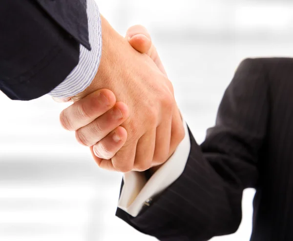 stock image Business shaking hands. Bright blurred background.