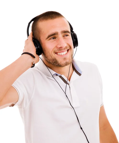Casual jovem ouvindo música com fones de ouvido, isolado no wh — Fotografia de Stock