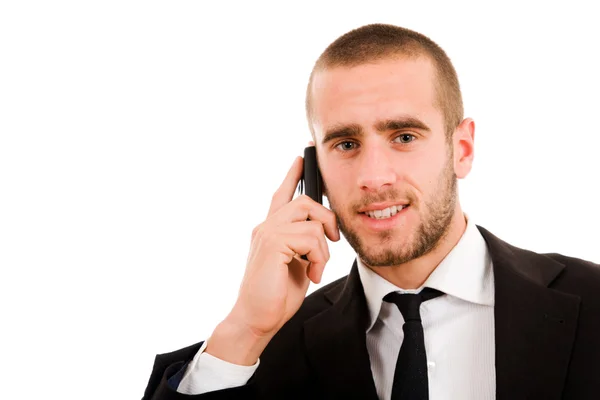 Jeune homme d'affaires souriant au téléphone, isolé sur blanc — Photo