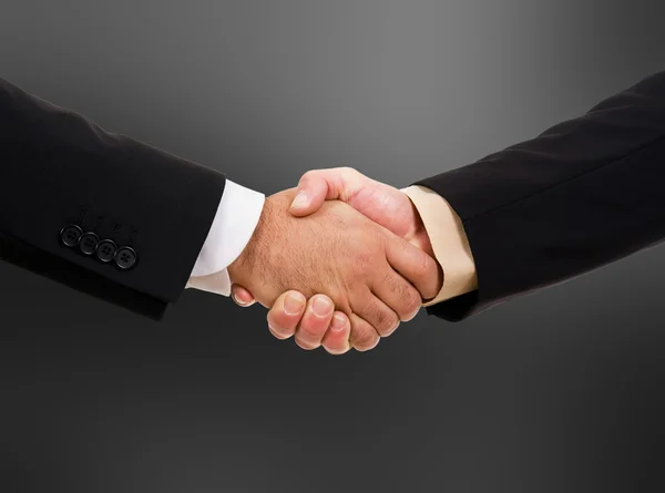 Handshake - ruka drží na černém pozadí — Stock fotografie