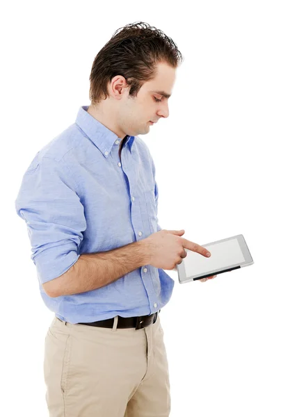 Młody mężczyzna pracujący z komputerem typu tablet przeciwko biały deseń — Zdjęcie stockowe