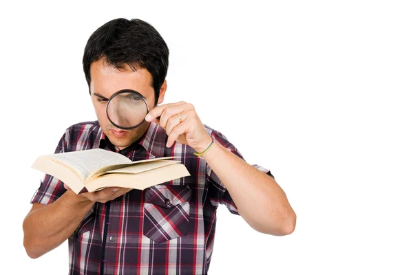 Young man reading a interesting book with magnifying glass, isol — Stock Photo, Image
