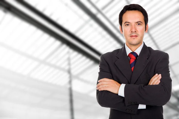 Closeup portrait of a smiling business man standing at a modern — Stock Photo, Image