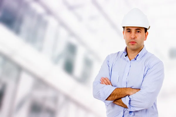 Male engineer standing at a building construction — Stock Photo, Image