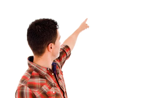 Visão traseira de um jovem homem casual apontando para algo sobre branco — Fotografia de Stock