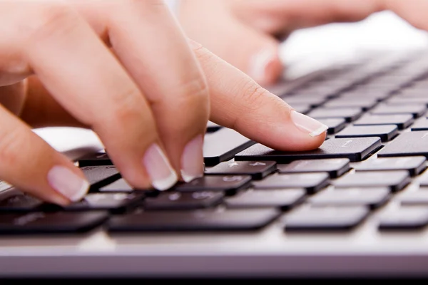 Крупный план руки секретаря, касающейся клавиши Вход на ноутбуке Durin — стоковое фото