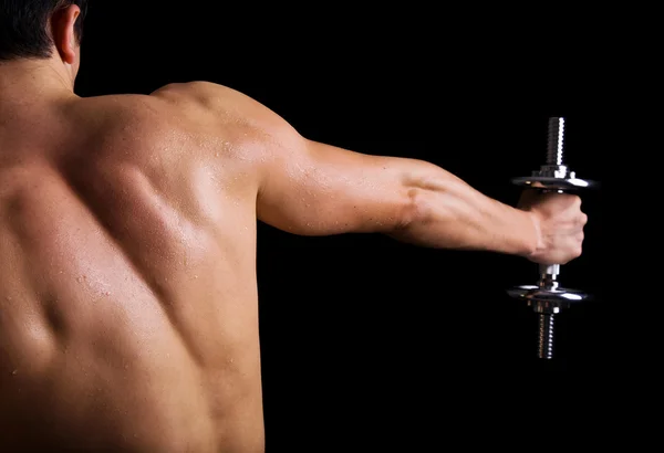Ağır siklet exercis yaparken bir genç erkek vücut geliştirmeci dikiz — Stok fotoğraf
