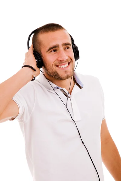 Hombre joven casual escuchando música con auriculares, aislado en wh —  Fotos de Stock