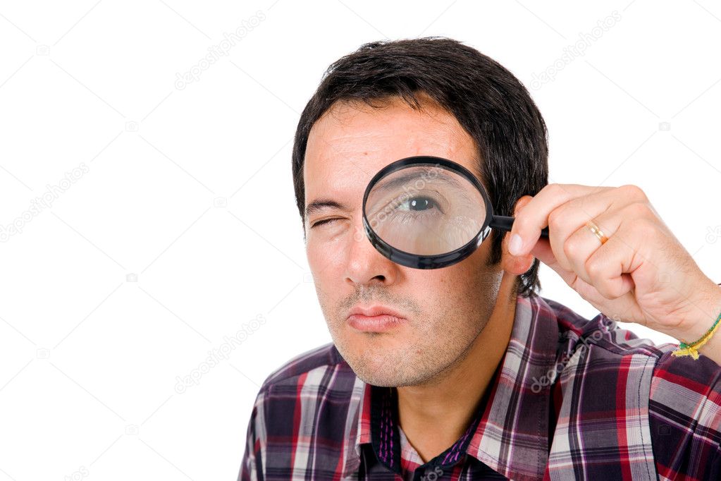 Funny image of a young man looking through magnifying glass, iso