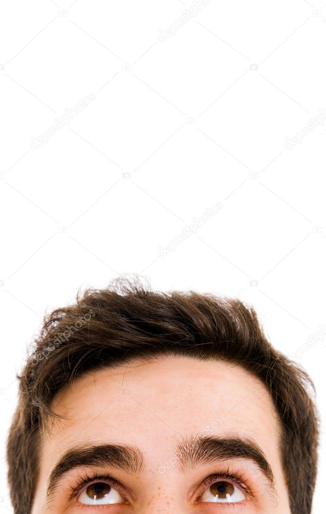 Close-up of young man looking up against white background