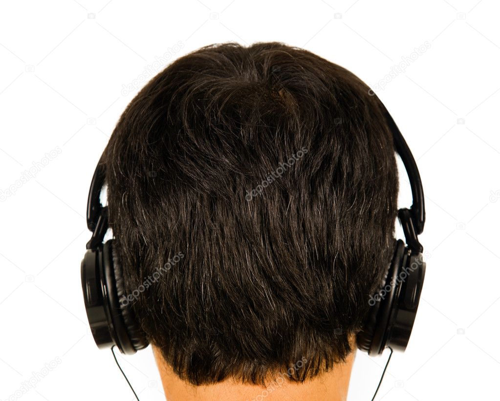 Back view of a man listening music with headphones. ( focus on h
