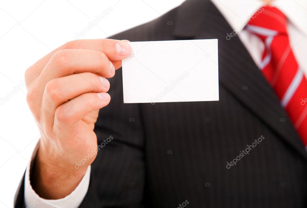 A studio shot of a businessman holding out a blank business card