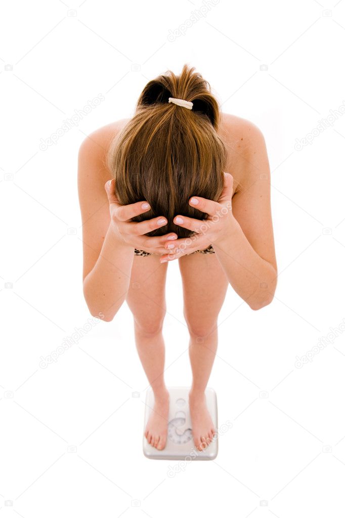 Top view of an unsuccessful female holding head while checking o