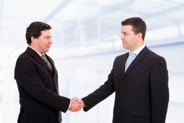 Business shaking hands, coming to an agreement in the off clipart