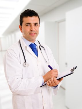 Smiling young medical doctor with stethoscope at the Hospital.