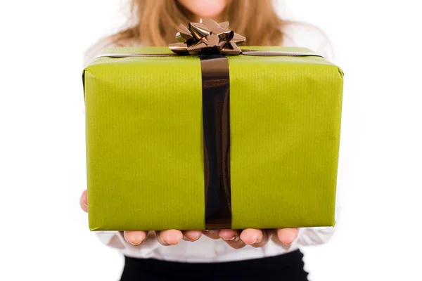 Close-up of young woman holding a gift over white background — Stock Photo, Image