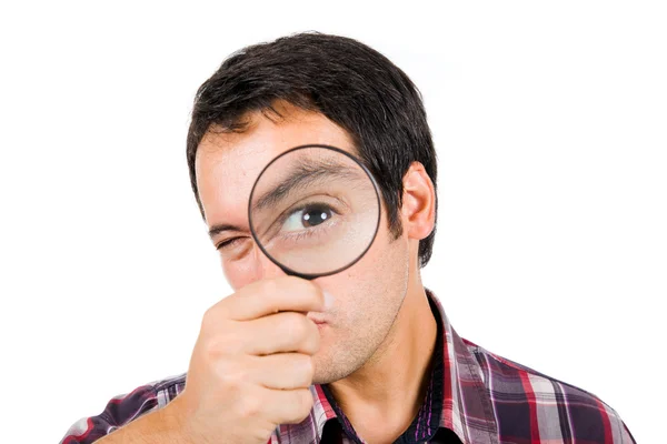 Funny image of a young man playing with a magnifying glass, isol — Stock Photo, Image