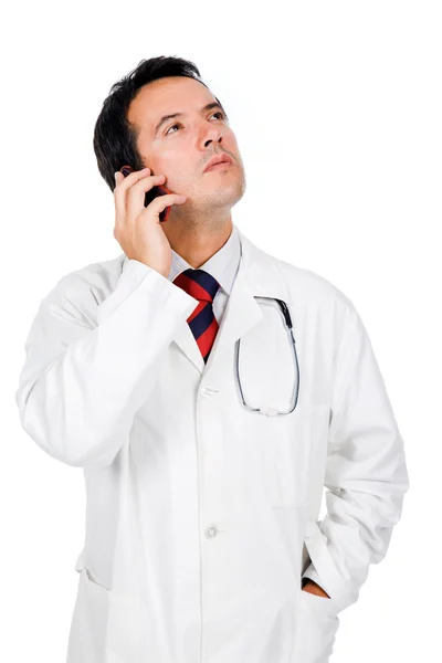 Thoughtful young doctor talking on the phone on white background — Stock Photo, Image