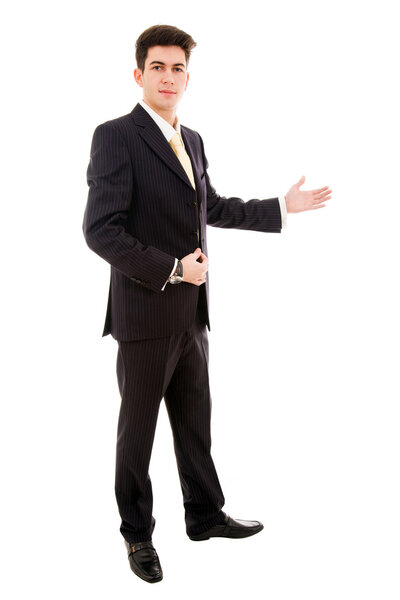 Young businessman with arm out in a welcoming gesture , isolated