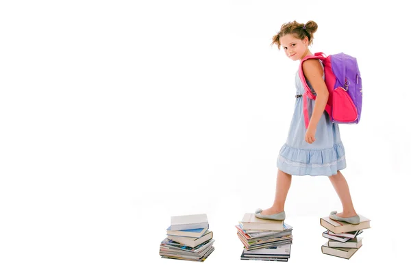 Portrait of litle girl with backpack walking from top to top of — Stock Photo, Image