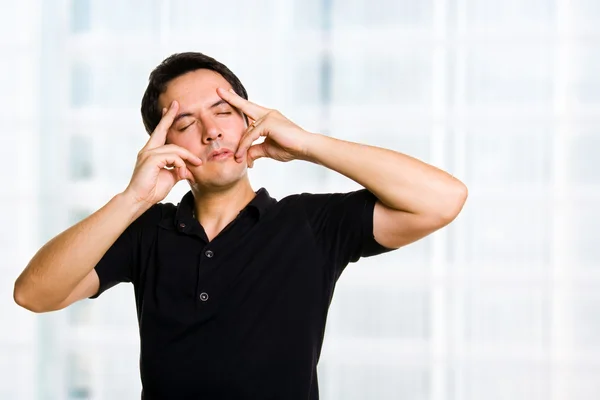 Young man having a headache at home — Stock Photo, Image