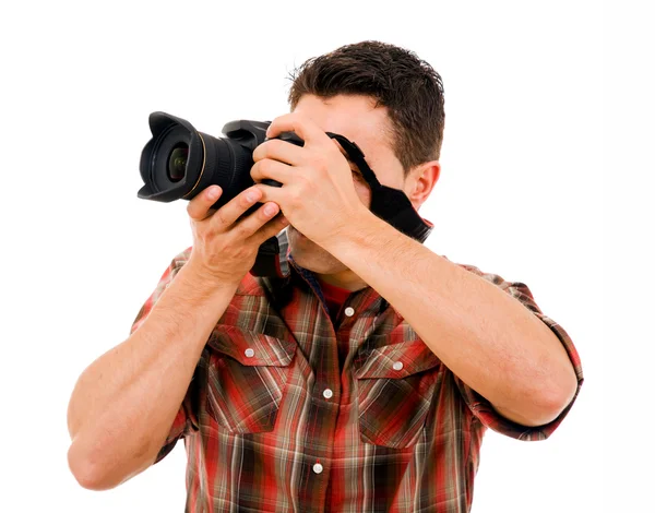 Activo joven fotógrafo con cámara, aislado en blanco — Foto de Stock