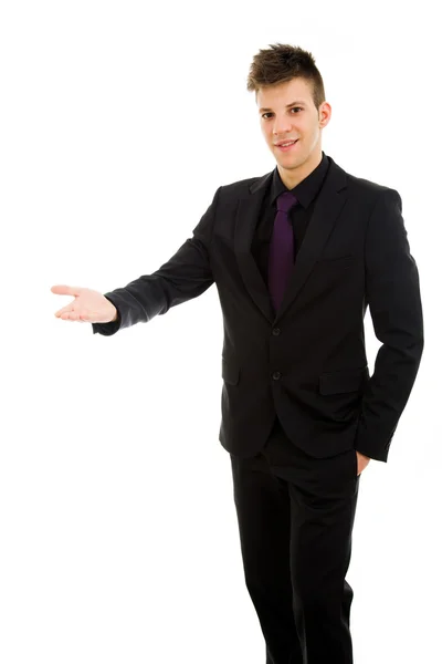 Glücklicher junger Geschäftsmann mit ausgestrecktem Arm in einer einladenden Geste, — Stockfoto