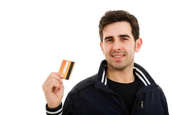 Щасливий молодий чоловік тримає кредитну картку, ізольований на білому — стокове фото