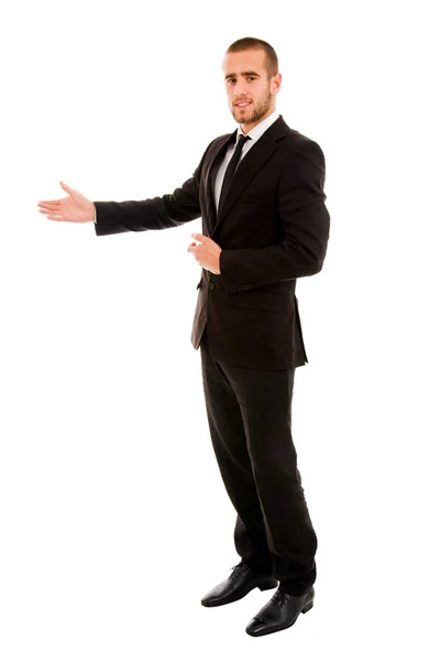 Junger Geschäftsmann in einladender Geste vor weißem Hintergrund — Stockfoto