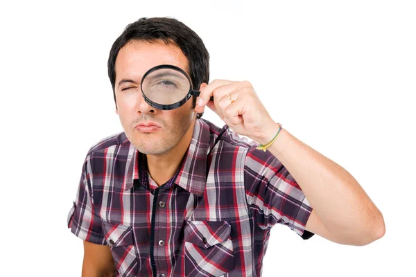Man looking through magnifying glass — Stock Photo, Image