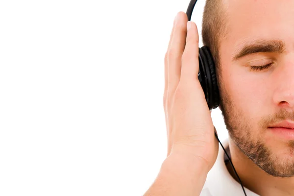 A young man listening to music — Stock Photo, Image