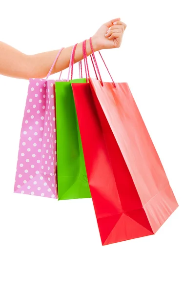 Mano femenina sosteniendo bolsas de compras coloridas —  Fotos de Stock